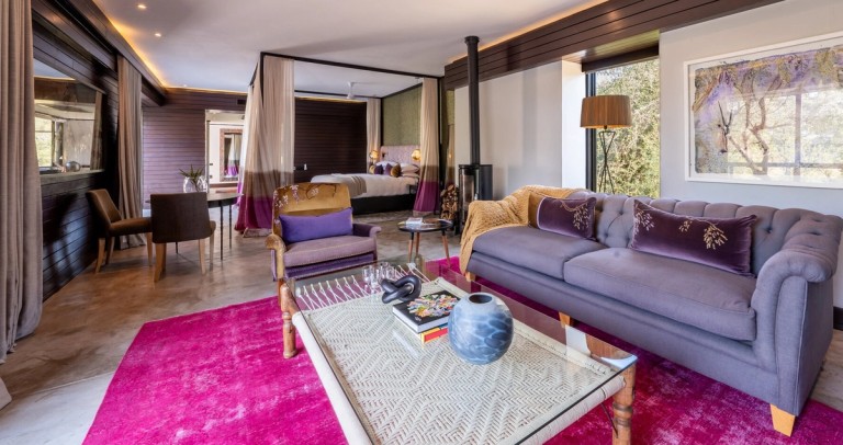 Silvan Safari Wisteria Suite This image showcases the beautifully decorated Wisteria Suite at Silvan Safari, featuring elegant furniture and a cozy atmosphere with a view of nature.