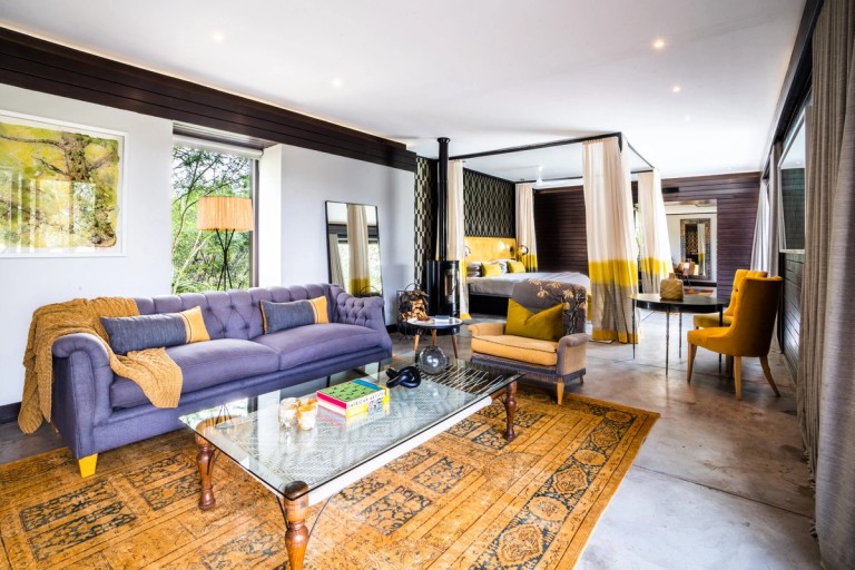 The image showcases the stylish interior of the Knobthorn Suite at Silvan Lodge, featuring a modern design with a comfortable seating area and elegant decor that blends luxury with nature.